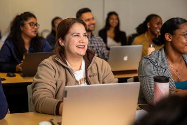 A group of diverse PACE students attentively engaged in a classroom session.